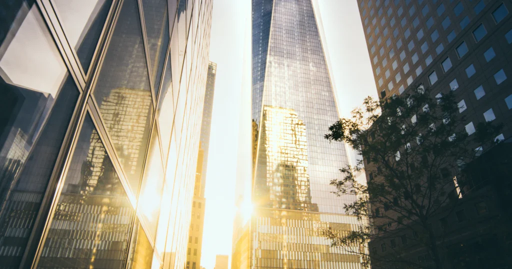 Morning light reflected between New York office towers; illustrative photograph for the September 2026 stock market outlook.